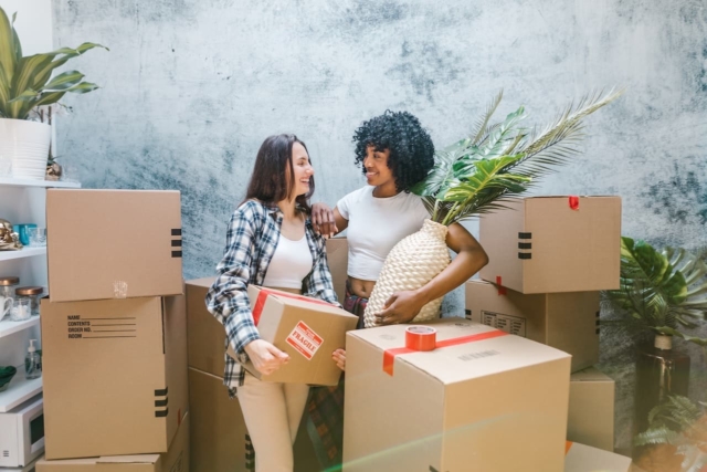 Two women surrounded by moving boxes